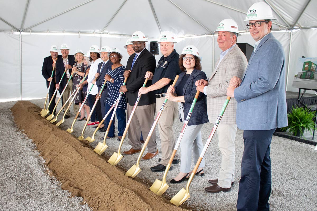 Pryor_GroundBreaking_Group Group of people standing behind dirt with shovels