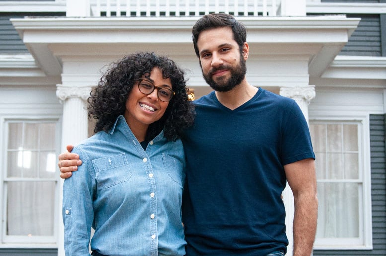 couple standing in front of home